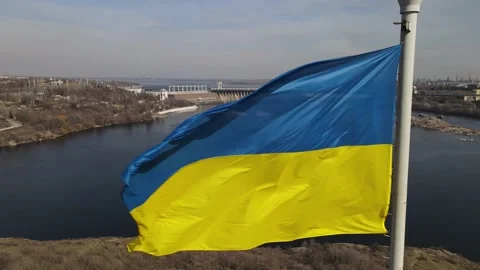 The flag of ukraine is developing in the wind, a view of the dam, the Dnieper Stock Footage 151459917