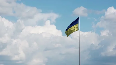 The flag of ukraine develops against the background of the sky with clouds. Stock Footage 157648997