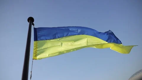 The flag of Ukraine develops on a flagpole against a background of clear sky Stock Footage 167923328