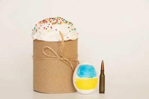 The flag of Ukraine is drawn on the egg, next to it is a bullet and an East.. Stock Photos