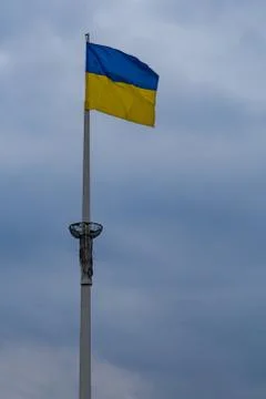 Flag of Ukraine on a flagpole behind thunderclouds Stock Photos