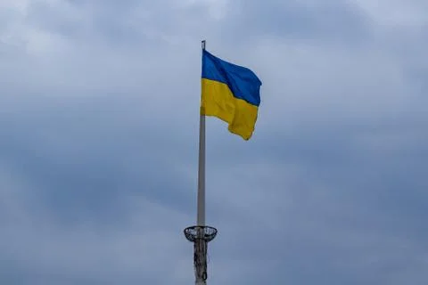 Flag of Ukraine on a flagpole behind thunderclouds Stock Photos