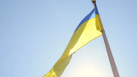 Flag of Ukraine on flagpole. Slow motion of Ukraine flag waving background sky Stock Footage 310428464