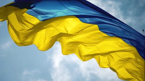 The flag of Ukraine flutters against the background of the sky. Видео 201214397