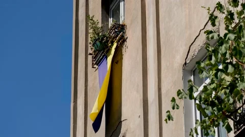 The flag of Ukraine hangs by the window Stock Footage 216473245