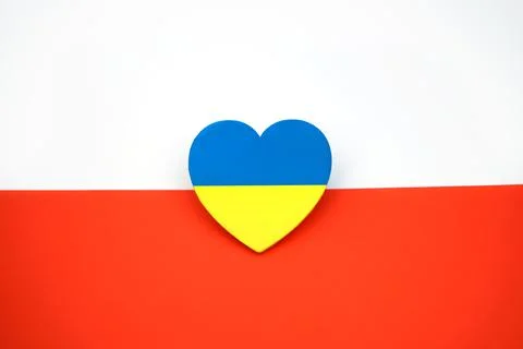 Flag of Ukraine in shape of heart on background of flag of Poland. Symbol of Stock Illustration