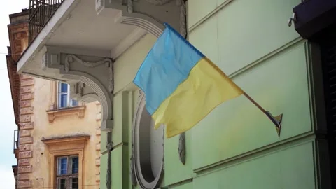 Flag of Ukraine in the wind on the facade. The yellow-blue flag Stock Footage 199124925