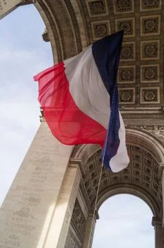 Flag underneath the Arc de Triomphe Stock Photos