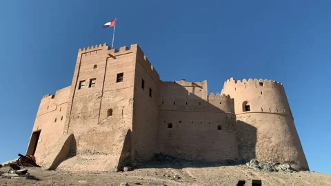 Flag of the United Arab Emirates (UAE) is waving on top  of Fujairah fort Stock Footage 298910480