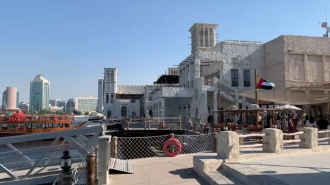 Flag of the United Arab Emirates (UAE) is waving at Dubai old village. Dubai Stock Footage 298911535