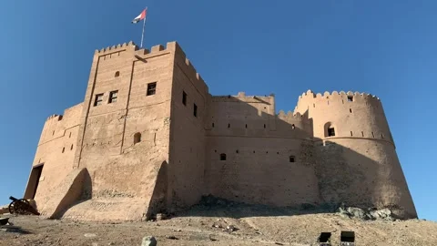 Flag of the United Arab Emirates (UAE) is waving on top  of Fujairah fort Stock Footage 298918928