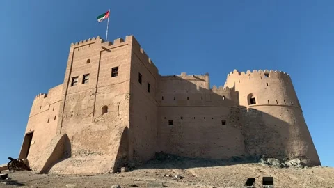 Flag of the United Arab Emirates (UAE) is waving on top  of Fujairah fort Stock Footage 298918965
