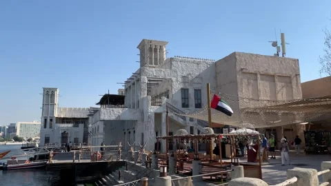 Flag of the United Arab Emirates (UAE) is waving at Dubai old village. Dubai Stock Footage 298919070