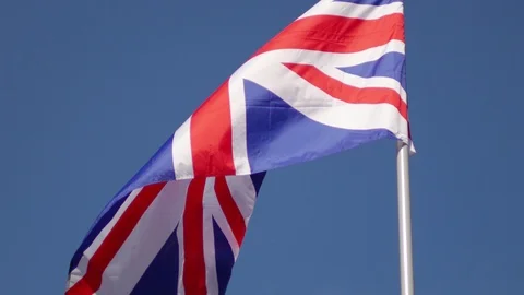 The flag of the United Kingdom develops against the blue sky 스톡 동영상 89941985