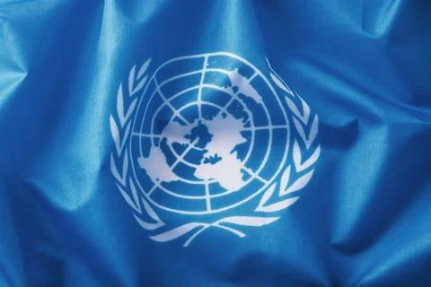 Flag of the United Nations waving in the wind background macro shot Fotos de archivo