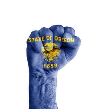 Flag of US Oregon state painted on human fist like victory symbol Stock Photos