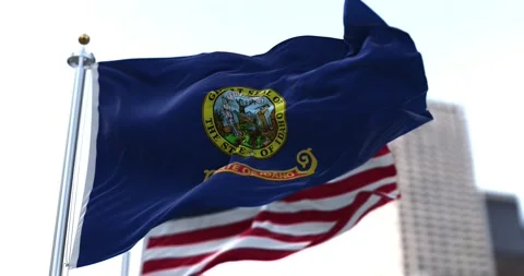 The flag of the US state of Idaho waving in the wind with the American stars Stock Footage 162316218