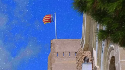 Flag of Valencia (Spain) flying over the building against the blue sky Stock Footage 330901364