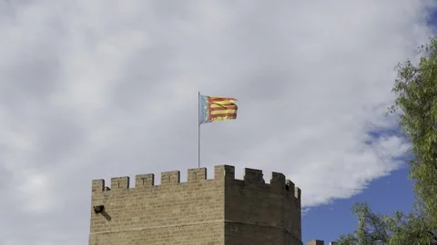 Flag of Valencian Community flying on top of Serranos Towers in Valencia Stock Footage 255288324