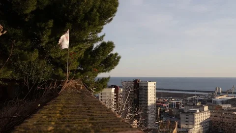 Flag on a wall, in the background the city and the sea Stock Footage 101161973