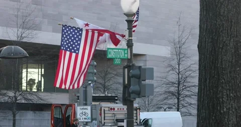 The flag of Washington, D.C. hangs beside the American flag for inauguration day Stock Footage 146627824