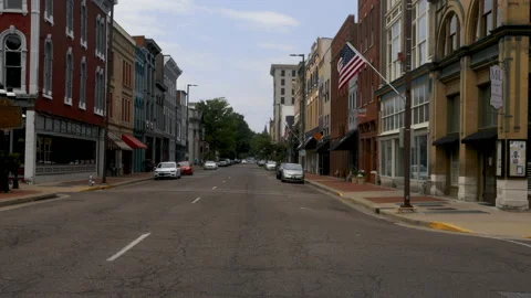 Flag waves over quiet city street in Paducah, KY on July 4th weekend Stock Footage 202747709