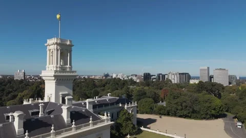 Flag Waving On Estate While passing Over Melbourne Royal Botanical Gardens Stock Footage 274606060