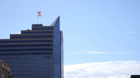 Flag Waving On Top of Modern Office Building Stock Footage 74366084