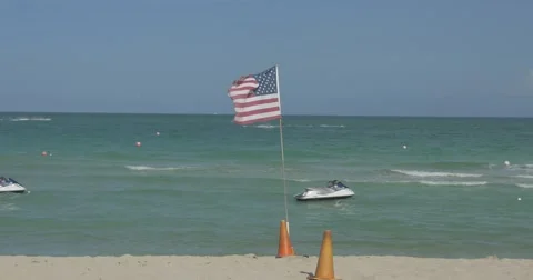 Flag waving in wind - Ocean and Jet Ski Stock Footage 60982066