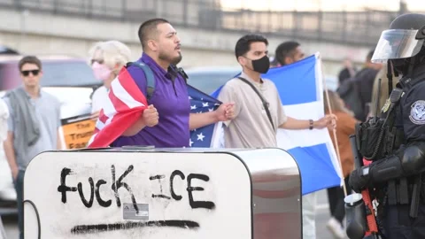 Flag-Wearing Anti-ICE Protesters Face CBP Police in Los Angeles Stock Footage 311091404