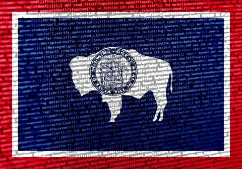 Flag of Wyoming over digital code. Concept of cybersecurity, innovation, an.. Photos