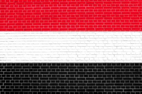 Flag of Yemen on brick wall texture background. Yemeni national flag. イラスト素材