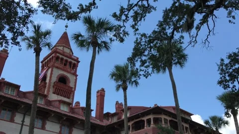 Flagler College, St. Augustine, Florida, seen through palm trees and oak Stock Footage 317695748