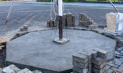 The flagpole structure is embedded into the fresh concrete foundation Foto stock