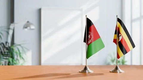 FLAGS OF AFGHANISTAN AND UGANDA ON TABLE Stock Photos