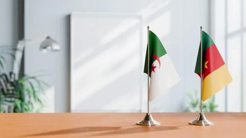 FLAGS OF ALGERIA AND CAMEROON ON TABLE Stock Photos