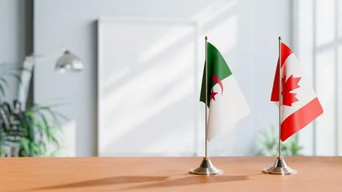 FLAGS OF ALGERIA AND CANADA ON TABLE Stock Photos