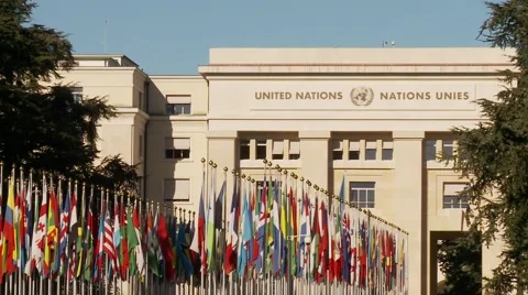Flags of all nations waving in front the UN Office in Geneva Stock Footage