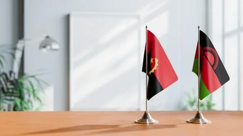 FLAGS OF  ANGOLA AND MALAWI  ON TABLE Stock Photos