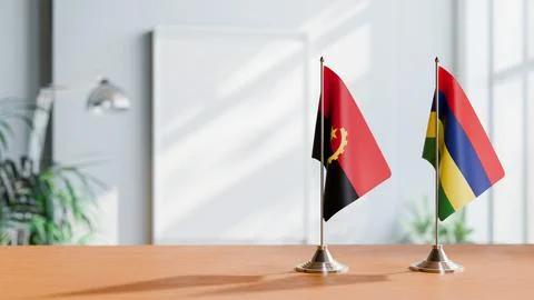 FLAGS OF  ANGOLA AND MAURITIUS  ON TABLE Stock Photos