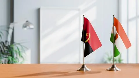 FLAGS OF  ANGOLA AND NIGER  ON TABLE Stock Photos