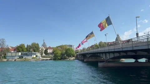 Flags are waving on bridge. Motion of cyclists and cars. Konstanz, Germany Stock Footage 315668886