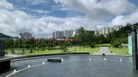 Flags are waving at United Nations Memorial Cemetary. Busan, South Korea Stock Footage 306573335