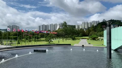 Flags are waving at United Nations Memorial Cemetary. Busan, South Korea Stock Footage 306573362