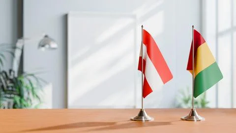 FLAGS OF  AUSTRIA AND GUINEA  ON TABLE Stock Photos