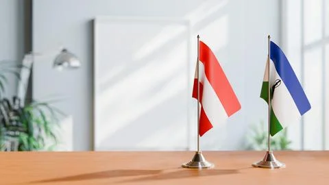 FLAGS OF  AUSTRIA AND LESOTHO  ON TABLE Stock Photos