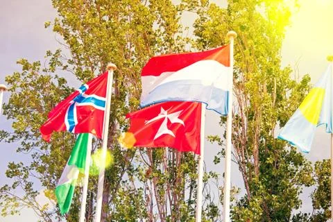 Flags  on the background of the blue sky in the sunlight Stock Photos