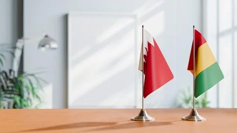 FLAGS OF  BAHRAIN AND GUINEA  ON TABLE Stock Photos