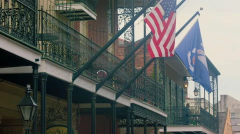 Flags on balconies, down to street view, French Quarter, New Orleans, LA Stock Footage 53359151