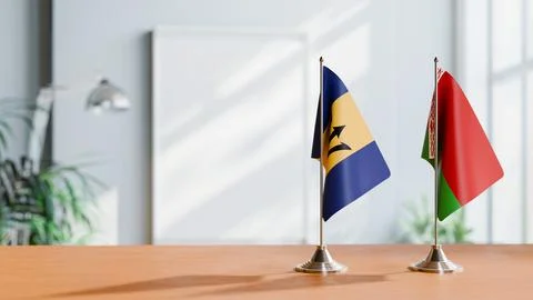 FLAGS OF  BARBADOS AND BELARUS  ON TABLE Stock Photos